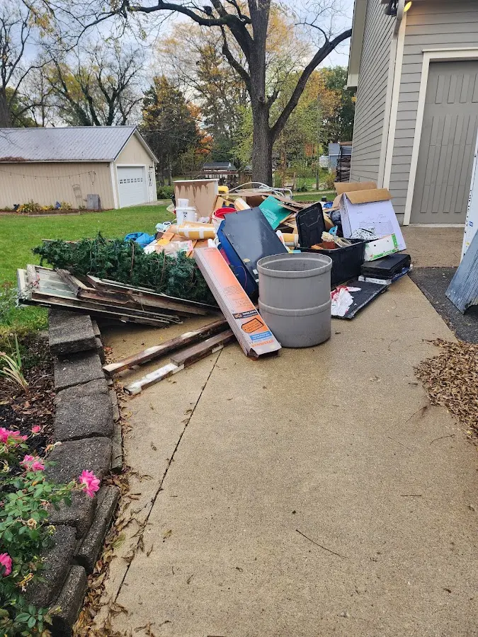 Dumpster being loaded with debris for Estate Cleanout Dumpster Rental in Excelsior Springs